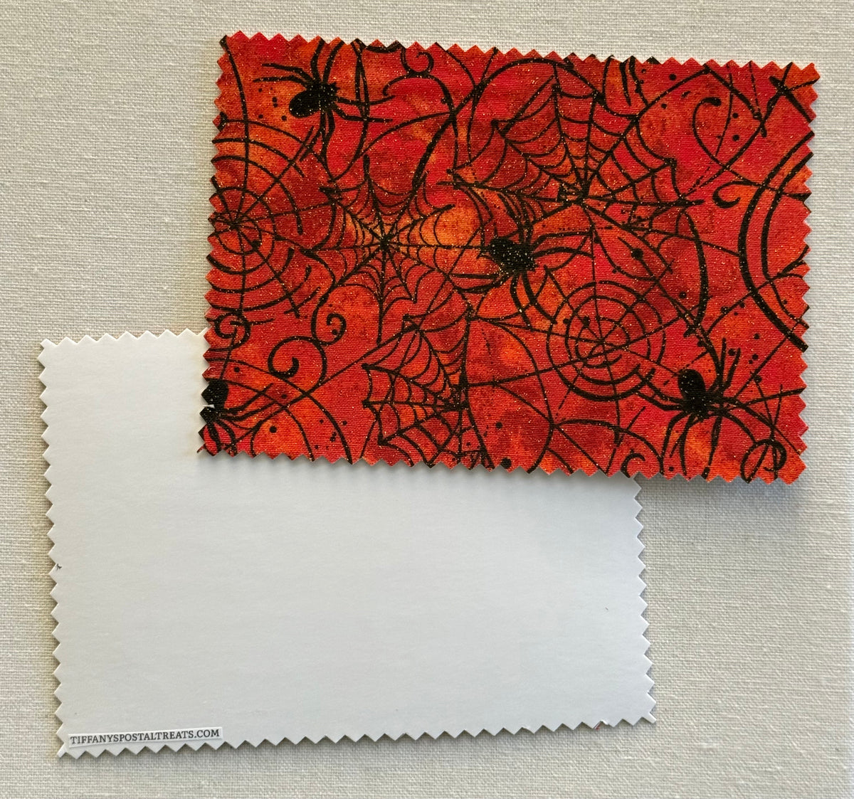 Halloween Fabric Postcard with Halloween-themed design featuring black spiders and webs with glitter accents.