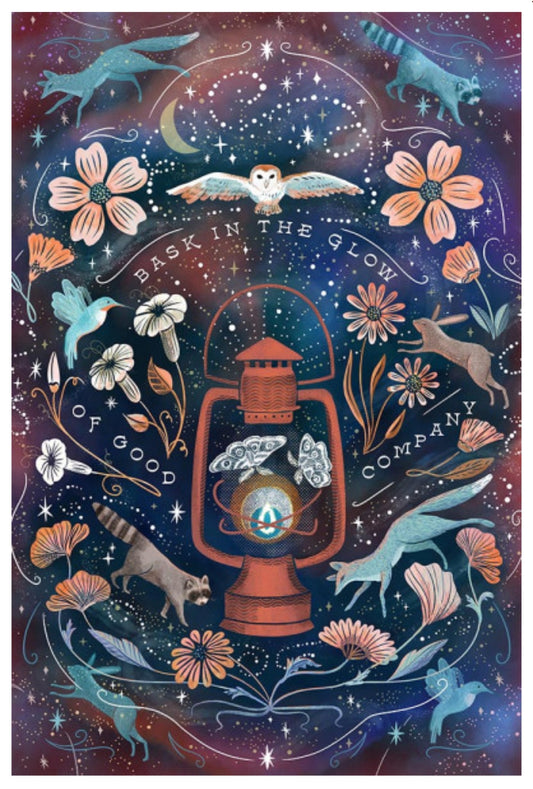 Bask In the Glow Postcard by Lantern Press featuring a glowing lantern at the center, surrounded by stars, flowers, birds, foxes, a raccoon, and the text 'BASK IN THE GLOW OF GOOD COMPANY'.