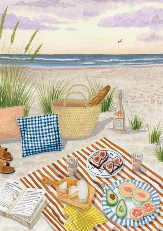 Beach Picnic postcard by Mélanie Voituriez featuring a picnic setup on a sandy beach with a basket, bread, and fruit, cheese and more.