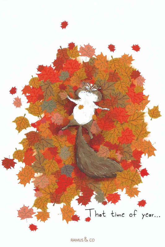 Chipmunk Joy Fall Postcard by Ramus & Company featuring a chipmunk surrounded by a dense cluster of red, orange, and yellow maple leaves, with the text 'That time of year.