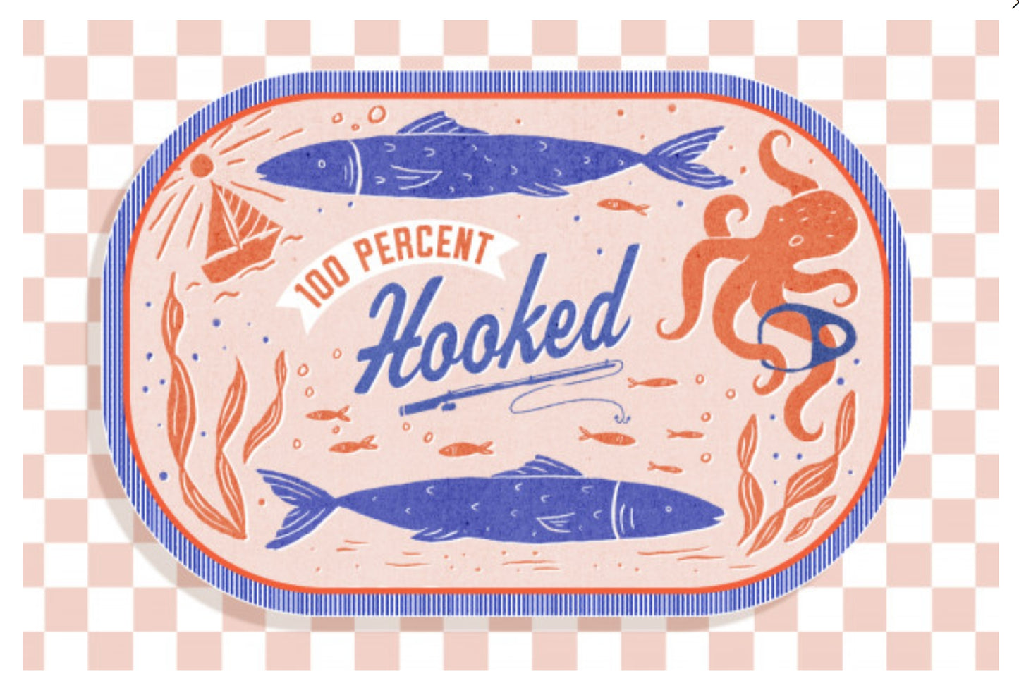 Dockside Series - 100% Hooked Postcard by Lantern Press featuring blue fish, an orange octopus, and the words “100 Percent Hooked” on a pale pink background