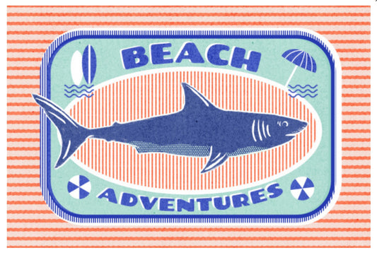 Dockside Series - Shark Postcard by Lantern Pres featuring a blue shark with the words 'BEACH ADVENTURES' and small beach-themed icons including a surfboard, waves, and umbrella on a coral-and-white striped background.