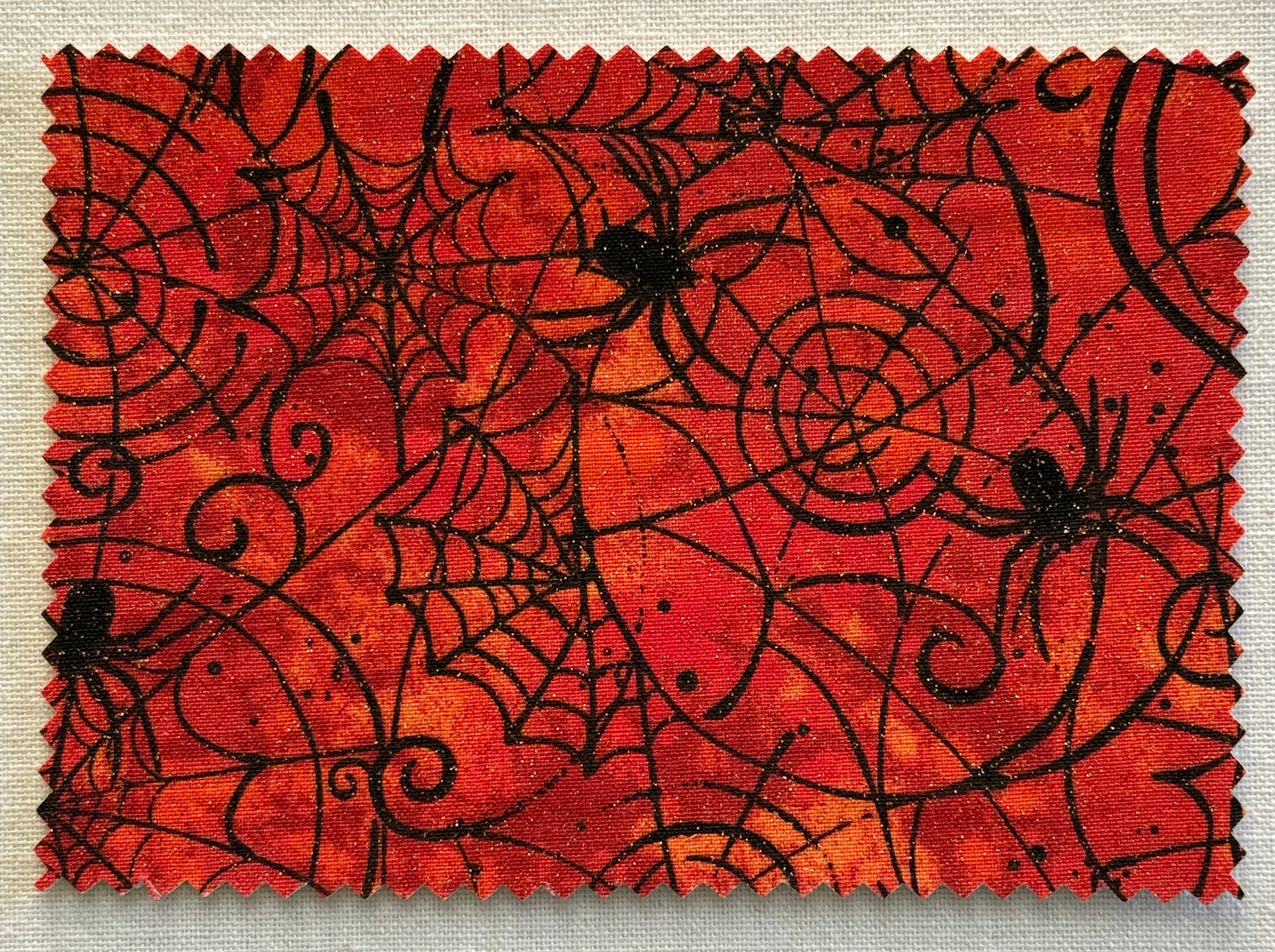 Halloween Fabric Postcard with Halloween-themed design featuring black spiders and webs with glitter accents.