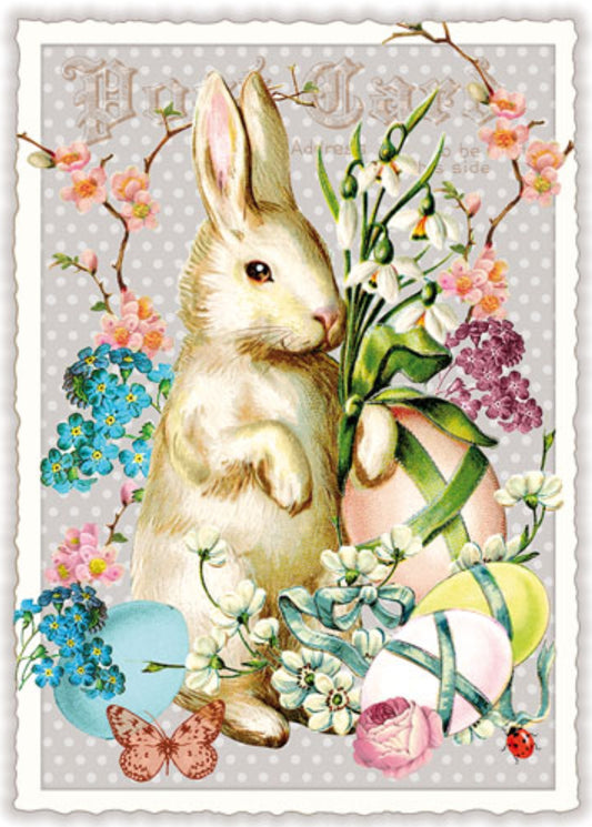 A vintage-style Easter Postcard by Edition Tausendschön featuring a rabbit, flowers, and eggs on a light gray background.