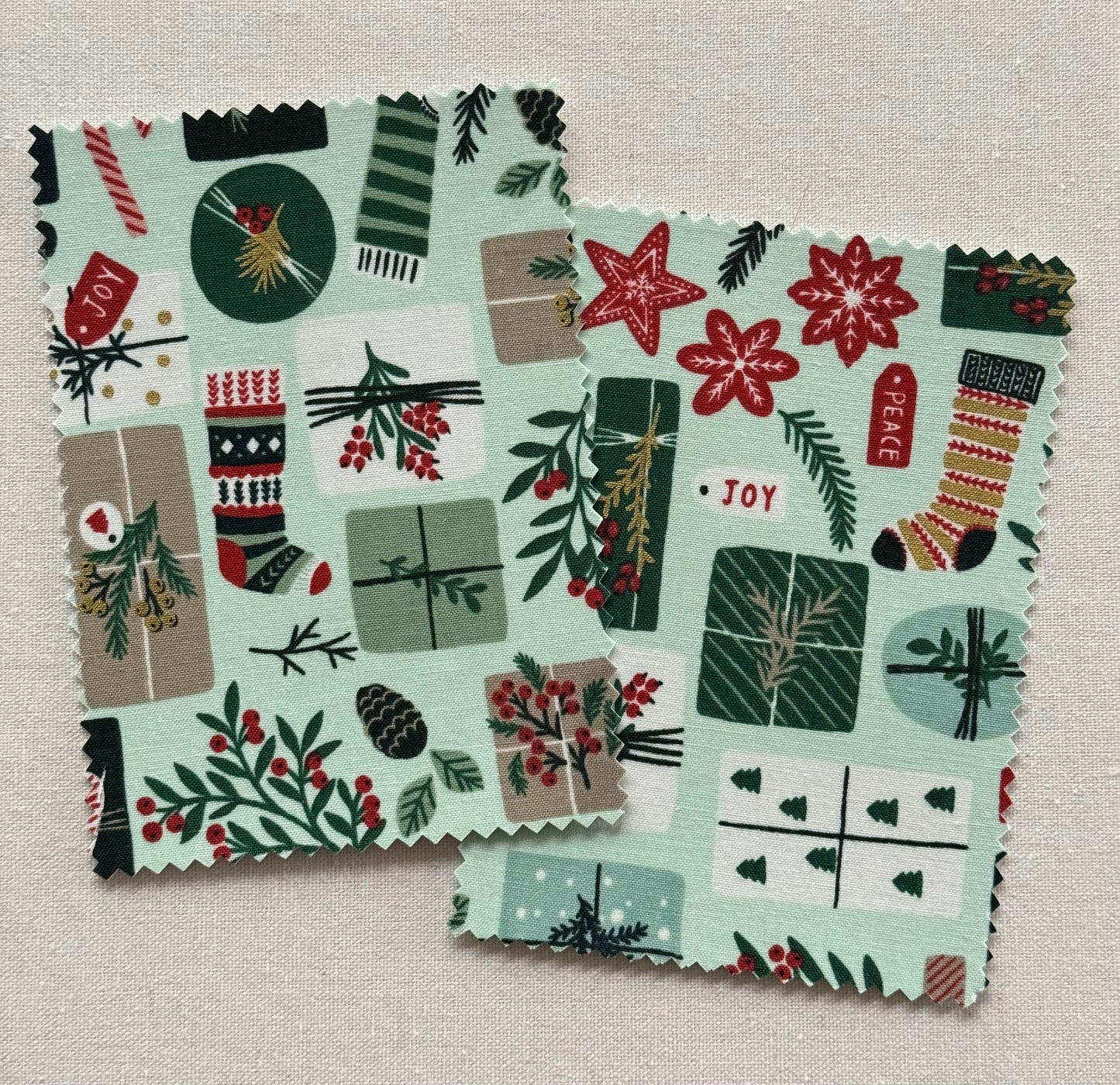 Fabric postcard with Christmas-themed pattern on a mint green background.