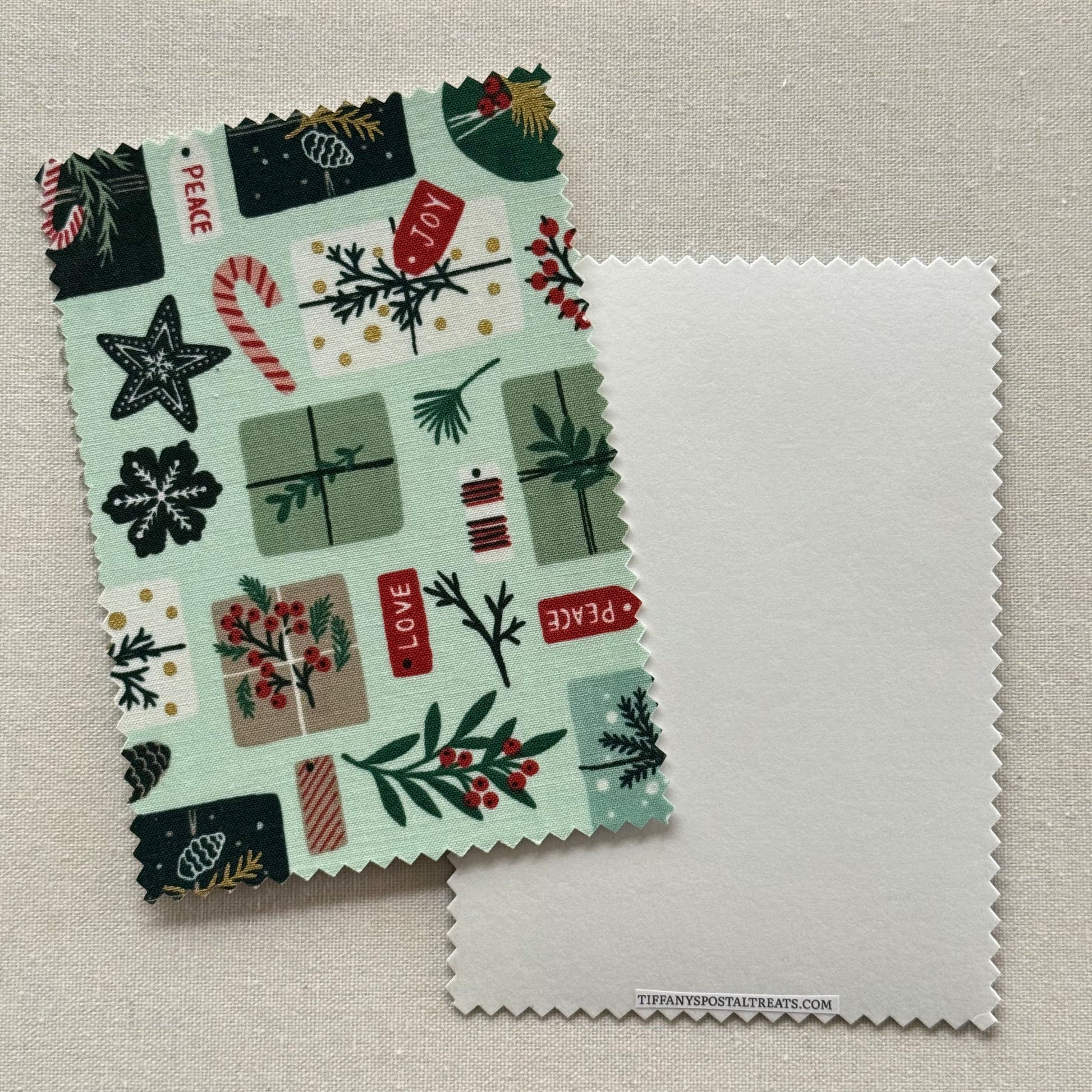 Fabric postcard with Christmas-themed pattern on a mint green background.