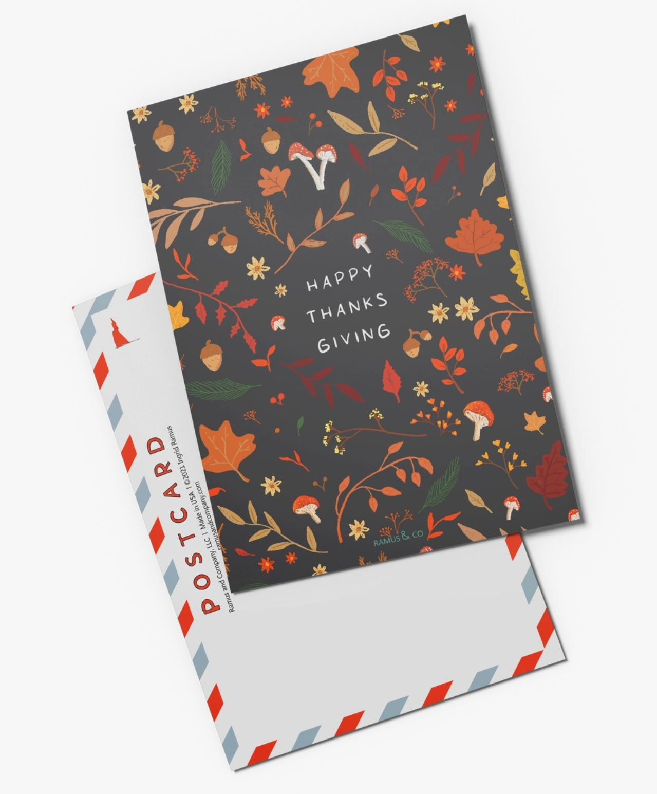 Happy Thanksgiving Postcard by Ramus & Company with a dark autumn-themed front featuring colorful leaves, acorns, mushrooms, and the words 'Happy Thanks Giving'