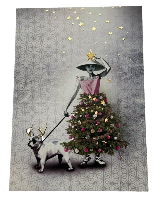 Christmas Tree Dress Postcard by La Tack for Nobis Design featuring a woman in a conical hat and pink dress walking a dog on a leash, with the dog wearing a reindeer antler headband. The woman's dress is shaped like a decorated Christmas tree, and gold stars decorate the gray patterned background.