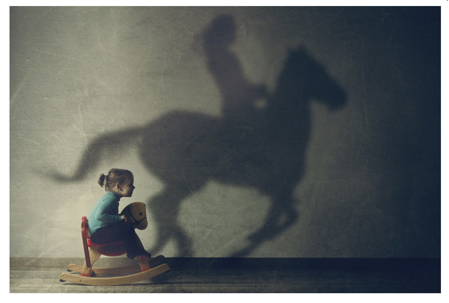 Lantern Press postcard featuring a vintage-style photograph of a girl with a rocking horse