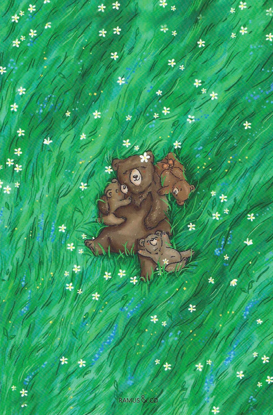 Mama Bear Postcard by Ramus & Company featuring a mother bear and three cubs nestled together in a vibrant green grassy field dotted with small white and blue flowers. 