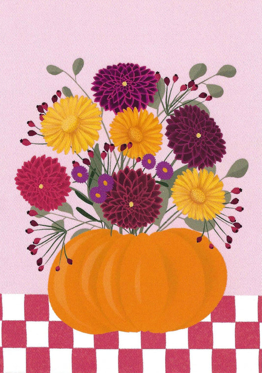 Pumpkin Flowers Postcard by Nobis Design featuring a pumpkin with a bouquet of flowers on a pink and red tablecloth with a pink background