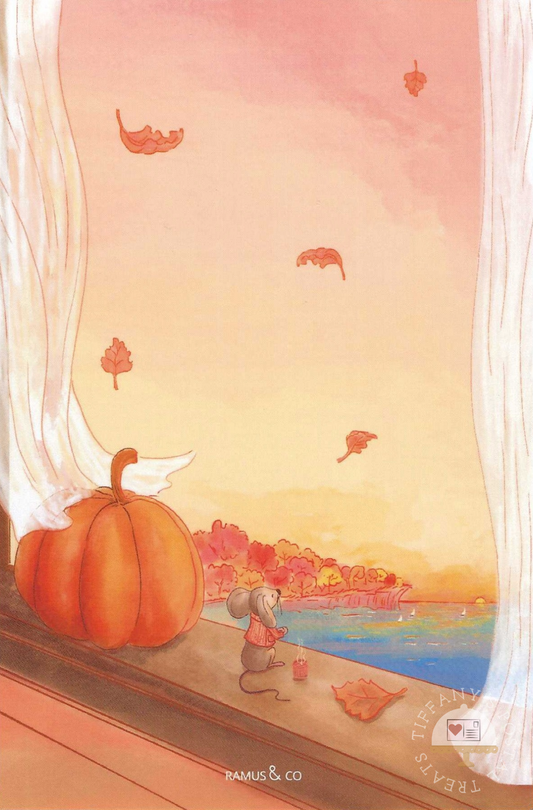 Autumn Mouse Postcard by Ramus & Co showing a small mouse standing by a window beside a large orange pumpkin, with falling leaves outside and a lake in the distance. The scene is framed by white curtains, with warm peach and yellow tones dominating the sky and water.