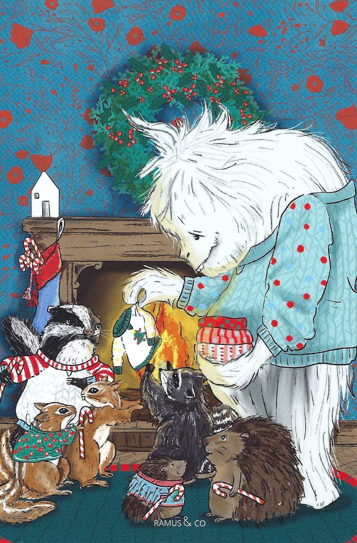 Yeti Sweater Club Postcard by Ramus and Company featuring a white Yeti  handing out Christmas Sweaters to several small animals around a fireplace. The background includes a blue patterned wall, a green wreath with red berries, stockings, and holiday decorations.