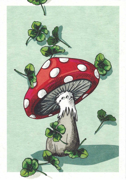 PEMO - Good Luck Postcard by Nobis Design featuring a red and white mushroom with green four-leaf clovers on a light green background