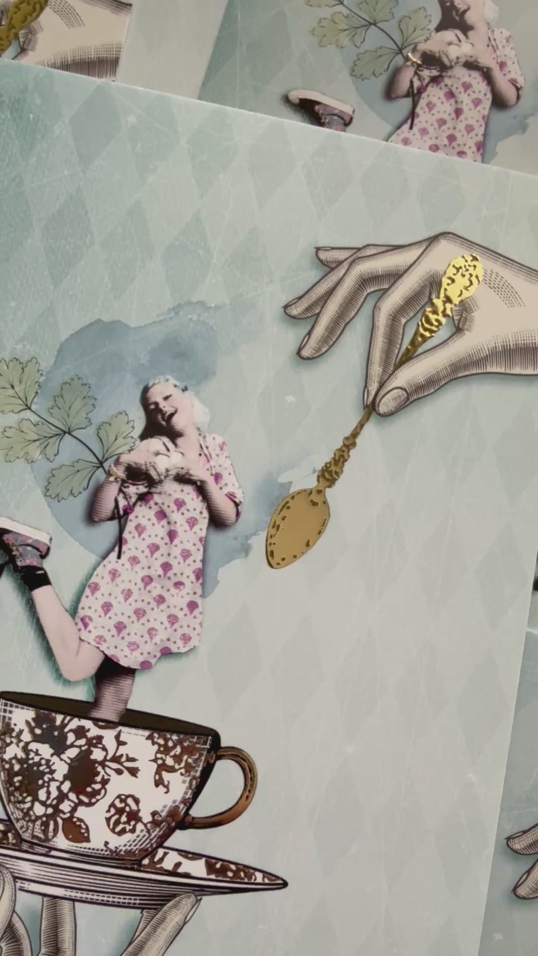 Golden Girl Postcard by La Tack for Nobis Design featuring an illustration of a girl in a dress being held in a teacup and saucer with a golden spoon above.